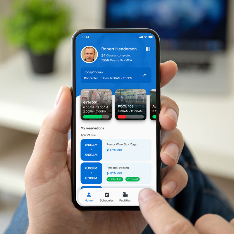person at home checking schedule at local gym