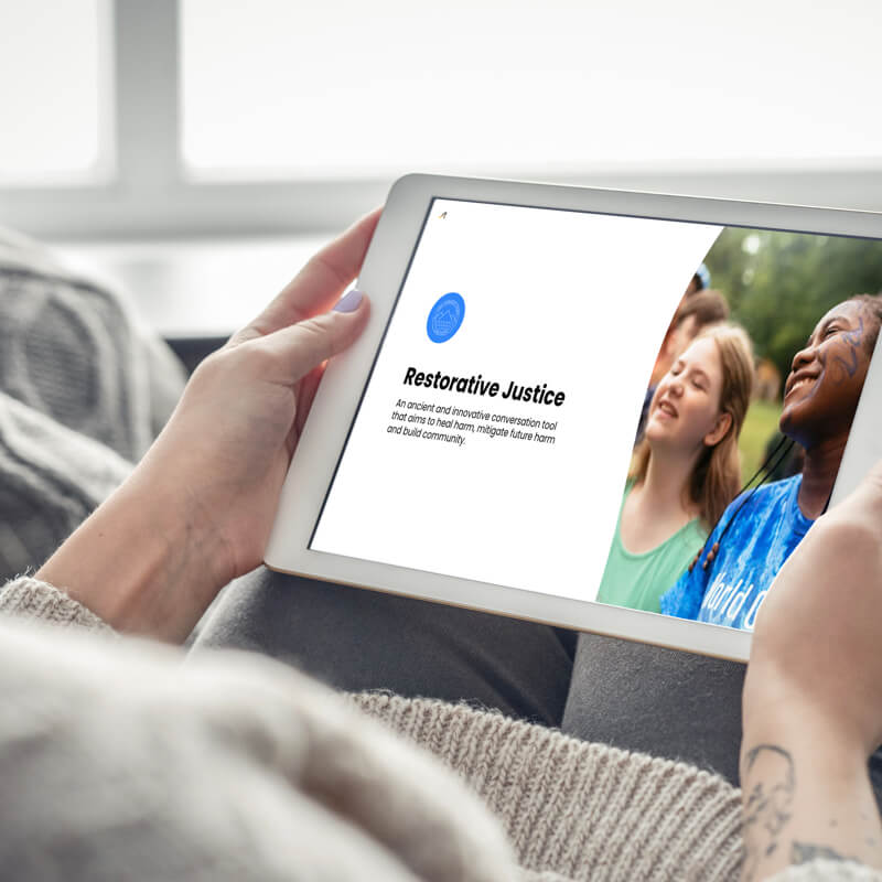 watching restorative justice webinar recording on a tablet