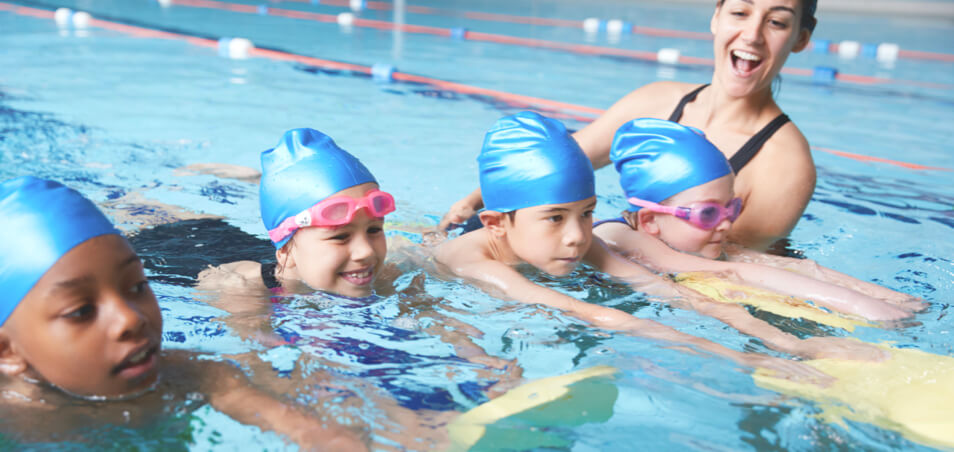 swim instructor and student during swim lessons in pool